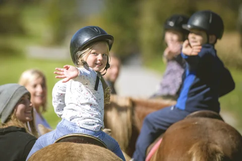 Children training horseback riding